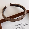 Detail view of brown twisted plaid headband with bow print and non-slip inner teeth - Dark Bow Style (27293D)