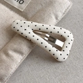 Macro detail of beige fabric polka dot hair clip showing fine texture and inner metal clip - White Style (27299A)