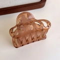 Close-up of cloud-shaped amber resin hair claw clip in translucent brown on wooden tray - Transparent Coffee Multi-tooth (27315K)