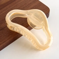 Detail of wavy irregular resin hair claw clip in translucent cream beige finish - Yellow Semi-circle