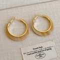 Detail of C-shaped resin earrings with marble texture and golden metal base - Beige-Yellow Acetate Style