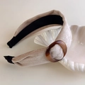 Detail of minimalist beige velvet headband with a stylish tortoiseshell resin ring decoration - Apricot