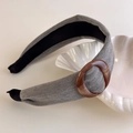 Close-up of gray velvet headband featuring a brown marble resin buckle detail on a shell - Gray