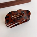 Detailed view of leopard print lip-shaped hair claw clip with shell texture - Dark Leopard Small Heart Clip (27373J)