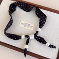 Detailed view of polka dot fabric choker with large pearls and marble slider accessory - Black Polka Dot