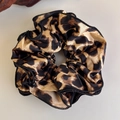 Macro shot of leopard print scrunchie with silk sheen and black edge stitching detail - Leopard Pattern Black Overlock Pleats (25831B)