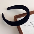 Close-up detail of a thick vintage black velvet headband with a smooth luxury texture - Black