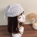 Close-up of a white polka dot square scarf worn as a headscarf with a knot detail - White Base Polka Dot