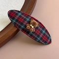 Detail of red plaid fabric hair clip featuring a cute 3D brown flocked bear ornament - Red/Black Plaid
