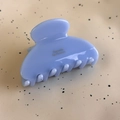 Detailed close-up of light blue acetate hair claw clip with golden Barrette la France text - Sky Blue