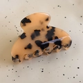 Macro shot of tortoiseshell acetate hair claw clip with gold Barrette la France logo - Tortoise