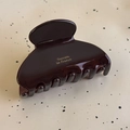 Detail view of small dark brown acetate hair claw clip with golden Barrette La France text - Dark Coffee