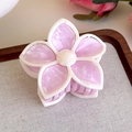 Close-up of pink marble flower hair claw with white border and pearl center on tray - Purple Multi-color