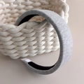Detail of grey knitted fabric headband with non-slip lining for high top look - Light Gray