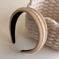 Detailed view of wide suede-like headband showing thick beige fabric texture on woven basket - Apricot