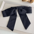 Detail of elegant large black satin bow hair clip on a premium display tray - Black (27128B)