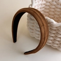 Detailed view of the brown suede headband with a non-slip black lining on a woven basket - Brown
