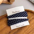Close-up of handmade navy blue plaid fabric hair clips on a wooden tray set - Royal Blue Plaid Set