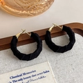 Detail of vintage black velvet wrapped hoop earrings with gold metal clasp on a rustic tray - Black (27427E)