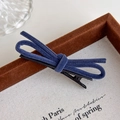 Detailed view of a navy blue velvet bow hair clip with a sturdy black metal duckbill base - Blue