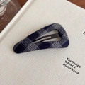 Detailed view of a navy blue plaid fabric triangle BB hair clip on a book background - Navy Blue Plaid Triangle Style