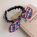 Detail view of preppy style plaid headband featuring non-slip teeth and red stitching bow - Grid Style (27465C) / Navy Blue Grid