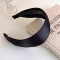 Detail of black satin wide headband with anti-slip inner teeth on fabric texture - Black
