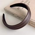 Detail shot of a mocha brown faux leather padded headband with a textured weave - Brown Coffee