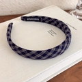 Detailed texture of navy and grey plaid headband with a handmade woven label on book - Royal Blue Plaid