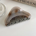 Detail of a smoky grey acetate claw clip with gold French Barrette engraving on a table - Phantom Grey