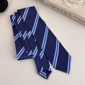Detail of navy blue necktie with light blue diagonal stripes on an elegant desktop - Dark and Light Blue Striped Style (27316G)