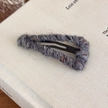 Close-up of triangle wool yarn wrapped metal BB hair clip with textured grey fiber detail - Gray