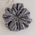 Close-up of gray knitted scrunchie featuring elegant dark brown vertical stripes - Hair Tie / Gray