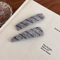 Detail of two gray knit BB hair clips with diagonal stripes on a vintage book - Gray Diagonal Stripe (27529C) / Gray