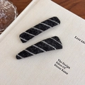 Close-up of black and white striped plush hair clips on a white minimalist background - Black White Stripe (27529E) / Black