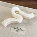Detailed close-up of a wavy cream-white hair claw clip with golden metal spring - 7# Wave Geometric Style (26745C White)