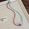 Detail of beaded necklace featuring red and blue beads with a cute mushroom pendant - Red Blue Splicing (26907B)