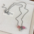 Detailed view of silver necklace with pink donut bead and metallic waterdrop pendant - Pink Style (26928B)