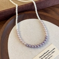 Detailed macro view of gradient pink and purple pearl necklace on a textured tray - Gradient Purple (26942A)