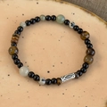 Detail view of tiger eye and onyx beaded bracelet with engraved silver fish charm - Beads Style (26948A)