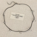 Detail view of minimalist necklace with transparent water drop charms on black cord - Black Style (26932C) / Black