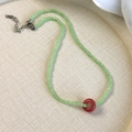 Close-up of green crystal beaded necklace with red ring pendant and metal lobster clasp - Green Necklace (26962D)