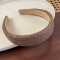 Detailed close-up of a brown woven straw wide headband featuring a soft beige fabric lining - Coffee