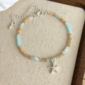Close-up of ocean-style beaded bracelet with silver starfish charm and white pearls - Starfish Charm (27030B)