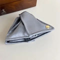 Close-up of gray satin triangle hair claw with gold medal engraved Believe in Yourself - Blue