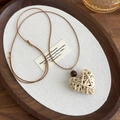Close-up of heart-shaped woven pendant with wood bead on adjustable wax cord necklace - Light Color Heart