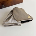 Detail of satin shell hair claw with gold believe button and elegant fabric texture - Grey Coffee
