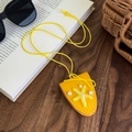 Gros plan d'un pendentif étoile de mer jaune tressé avec perles sur un bureau en bois - Jaune
