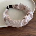 Dettaglio di un cerchietto di lusso in raso champagne con strass lucidi su base in legno - Cerchietto Rosa Albicocca
