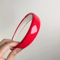 Close-up of a glossy red patent leather sponge headband with shiny finish and non-slip lining - Red (27077C)